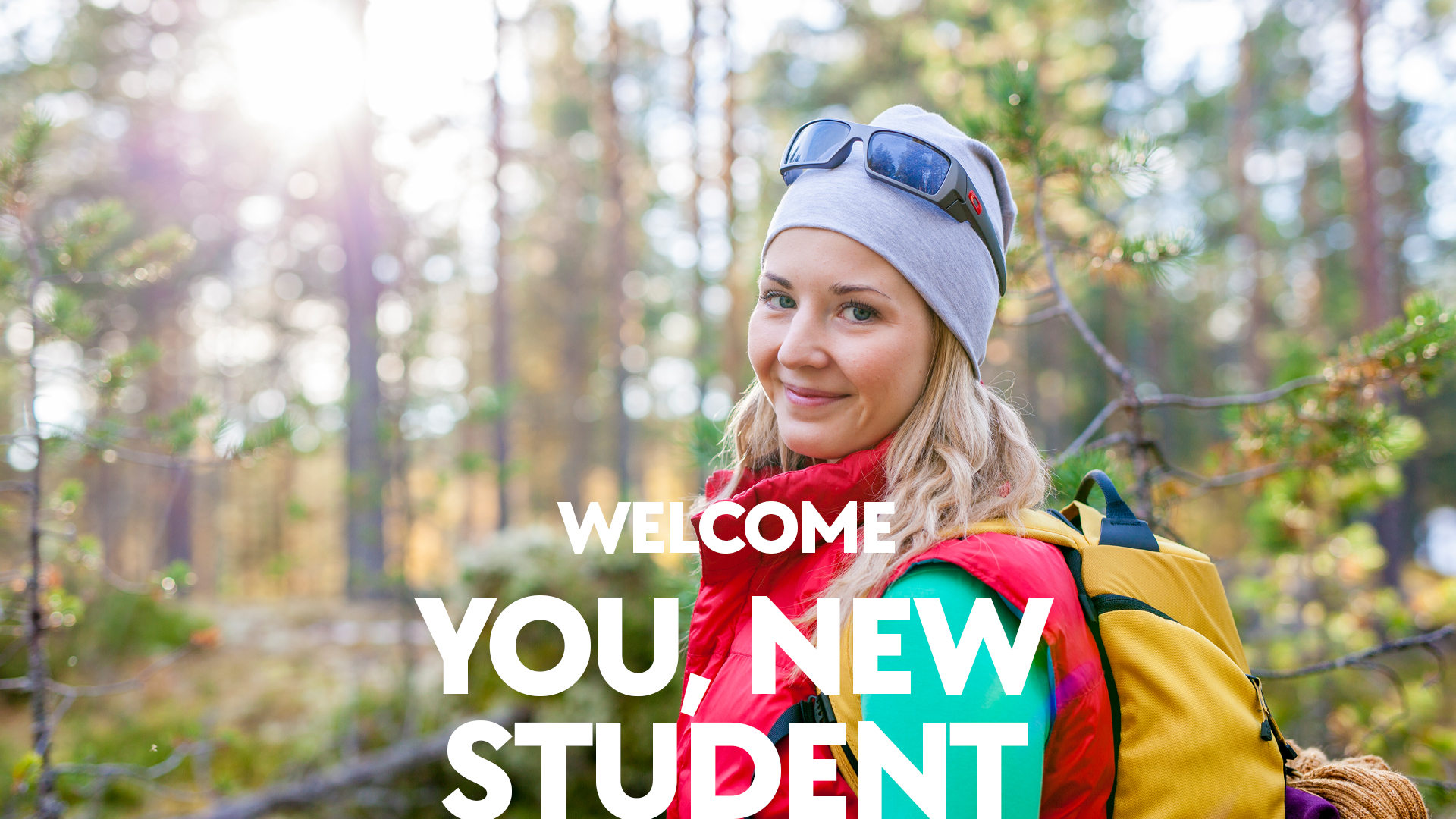 A woman in the forest with camping attire. Text at the bottom that says Welcome you, new student