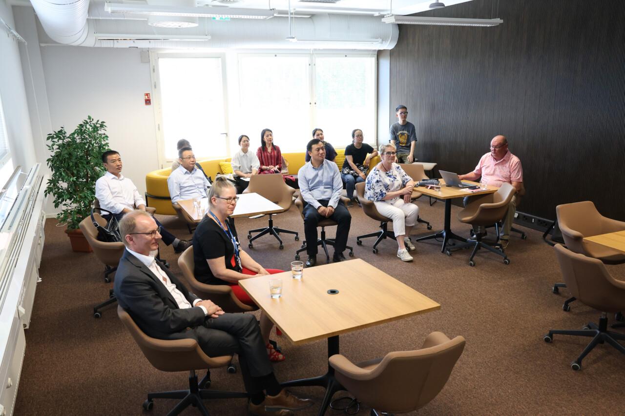 Group of people are sitting in meeting room.