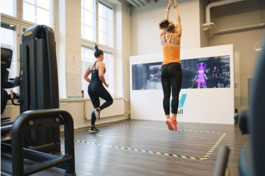 Two people moving in front of iWall in a gymnasium. Picture: CSE Entertainment.